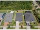 Aerial view of three modern homes each with fenced yard and landscaping, one with screened in pool at 12905 Satin Lily Dr, Riverview, FL 33579