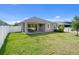 A spacious backyard with green grass is perfect for outdoor activities and leisure in this well-maintained property at 12905 Satin Lily Dr, Riverview, FL 33579