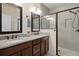 Bathroom features dual sinks, granite counters, and walk-in shower at 12905 Satin Lily Dr, Riverview, FL 33579