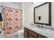 Bathroom with a tub, shower with floral curtain, and a modern vanity with granite countertop at 12905 Satin Lily Dr, Riverview, FL 33579