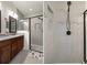 Modern bathroom featuring a glass-enclosed shower, gray tile and a double vanity with granite countertop at 12905 Satin Lily Dr, Riverview, FL 33579