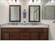 Bathroom with double vanity, granite countertop, modern fixtures, and a glass-enclosed shower at 12905 Satin Lily Dr, Riverview, FL 33579