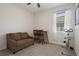 Comfortable bedroom featuring a couch, exercise bike, and window for natural light at 12905 Satin Lily Dr, Riverview, FL 33579