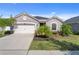 Charming one-story home featuring a two-car garage and beautifully landscaped front yard at 12905 Satin Lily Dr, Riverview, FL 33579