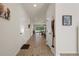 Bright hallway featuring wood-look tile flooring, leading to the open living spaces at 12905 Satin Lily Dr, Riverview, FL 33579