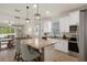 Open-concept kitchen flows into living room, boasting stainless steel appliances at 12905 Satin Lily Dr, Riverview, FL 33579