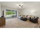 Cozy living room with tile floors, sliding glass doors to backyard, and comfortable furniture at 12905 Satin Lily Dr, Riverview, FL 33579
