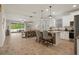Open-concept living space boasts a kitchen island, dining area and sliding doors to the patio at 12905 Satin Lily Dr, Riverview, FL 33579