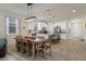 Stylish living space featuring an open kitchen, dining area, and modern lighting fixtures at 12905 Satin Lily Dr, Riverview, FL 33579
