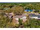 Aerial view of a cozy single-Gathering home with a neutral-toned roof, surrounded by mature trees in a serene neighborhood at 7105 N Whittier St, Tampa, FL 33617