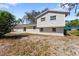 Back exterior featuring siding, windows, and doors at 7105 N Whittier St, Tampa, FL 33617