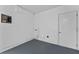 Unfinished basement with painted concrete floor, exposed pipes, and electrical box at 7105 N Whittier St, Tampa, FL 33617