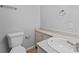 Well-lit bathroom showcasing modern toilet, vanity, and fixtures at 7105 N Whittier St, Tampa, FL 33617