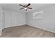 Bedroom featuring neutral paint, ceiling fan and wood-look floors at 7105 N Whittier St, Tampa, FL 33617