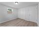 Bedroom featuring neutral paint, wood-look floors, and closet at 7105 N Whittier St, Tampa, FL 33617