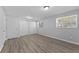 Bedroom featuring wood-look floors, two closets, and bright lighting at 7105 N Whittier St, Tampa, FL 33617