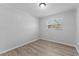 Cozy bedroom with wood-look floors and window at 7105 N Whittier St, Tampa, FL 33617
