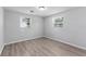 Bedroom featuring neutral paint, wood-look floors, and natural light at 7105 N Whittier St, Tampa, FL 33617