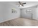 Bedroom featuring neutral paint, ceiling fan and wood-look floors at 7105 N Whittier St, Tampa, FL 33617