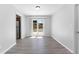 Dining room with wood-look flooring, modern light fixture, and sliding glass doors to the backyard at 7105 N Whittier St, Tampa, FL 33617