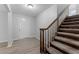 Bright entryway features wood-look flooring, leading to a staircase with carpeted steps and a wooden banister at 7105 N Whittier St, Tampa, FL 33617
