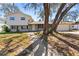 Charming two-story home with a brick facade, complemented by mature trees and a welcoming walkway to the front door at 7105 N Whittier St, Tampa, FL 33617