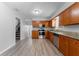 Well-lit kitchen featuring stainless steel appliances, granite countertops and wood-look floors at 7105 N Whittier St, Tampa, FL 33617