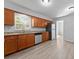 Bright kitchen with stainless steel appliances, granite countertops and wood-look floors at 7105 N Whittier St, Tampa, FL 33617