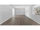 Bright and airy living room with wood-look flooring and plenty of natural light from two windows at 7105 N Whittier St, Tampa, FL 33617