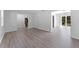 An open floorplan featuring wood-look floors, stairs, and sliding door access at 7105 N Whittier St, Tampa, FL 33617