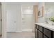 Bathroom featuring a sink with dark cabinets, shower, neutral colors, and decor at 30948 Silver Stage Dr, Brooksville, FL 34602