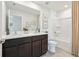 Bathroom featuring a double sink vanity, shower, neutral colors, and decor at 30948 Silver Stage Dr, Brooksville, FL 34602