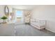 Cozy Bedroom with soft gray carpet, white furniture, and natural light from the window at 30948 Silver Stage Dr, Brooksville, FL 34602