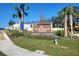 Sherman Oaks community sign with palm trees and manicured landscaping at 30948 Silver Stage Dr, Brooksville, FL 34602