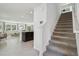 View of open-concept design with staircase, modern tile flooring, and a spacious living area with ample natural light at 30948 Silver Stage Dr, Brooksville, FL 34602