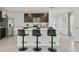 Stylish kitchen with a central island, dark cabinets, modern appliances, and bar stool seating at 30948 Silver Stage Dr, Brooksville, FL 34602