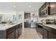 Well-equipped kitchen with stainless steel appliances, a breakfast bar, and dark cabinetry at 30948 Silver Stage Dr, Brooksville, FL 34602