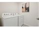 Laundry room featuring a washer and dryer with neutral paint and art at 30948 Silver Stage Dr, Brooksville, FL 34602