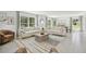 Bright and airy living room featuring two sofas, natural light, and an eye-catching rug at 30948 Silver Stage Dr, Brooksville, FL 34602