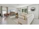 Comfortable living room with modern decor, large windows, stylish rug, and a cozy seating arrangement at 30948 Silver Stage Dr, Brooksville, FL 34602