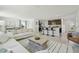 Open-concept living space showcasing a kitchen island, dining area, and comfortable living room with ample seating at 30948 Silver Stage Dr, Brooksville, FL 34602