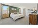 A main bedroom with natural light, green accent wall, and matching dresser at 30948 Silver Stage Dr, Brooksville, FL 34602