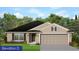 Charming single-story home featuring a two-car garage, neutral siding, dark roof, and manicured front lawn at 4889 Sutherland St # Lot 53, Spring Hill, FL 34609