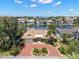 Stunning aerial view of the home highlighting the brick driveway, lush landscaping, and waterfront location at 852 3Rd Ave S, Tierra Verde, FL 33715