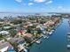 Waterfront home featuring a private pool, boat dock, and lush tropical landscaping at 852 3Rd Ave S, Tierra Verde, FL 33715