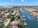 A high-angle view features the home's location on a canal with nearby boat docks at 852 3Rd Ave S, Tierra Verde, FL 33715