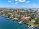 Stunning aerial view of a waterfront property with a private pool, boat dock, and convenient access to the bay at 852 3Rd Ave S, Tierra Verde, FL 33715
