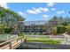 Beautiful backyard featuring a screened-in pool, lush landscaping, and private waterfront access at 852 3Rd Ave S, Tierra Verde, FL 33715