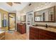 Elegant bathroom with granite countertops, wood cabinets, and a glass-enclosed shower at 852 3Rd Ave S, Tierra Verde, FL 33715