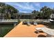Private dock features seating with waterfront views of beautiful palm trees at 852 3Rd Ave S, Tierra Verde, FL 33715